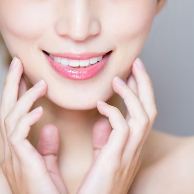 close up of beauty woman tooth on the gray background